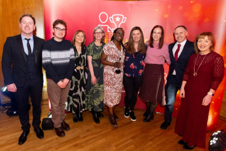 Team accepting their prize at the staff excellence awards